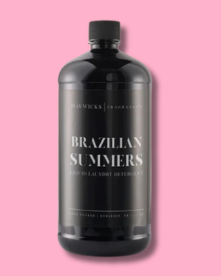 Black bottle of Maywicks Brazilian Summers laundry detergent on a pink background