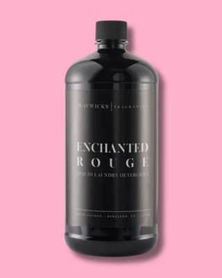 Black bottle of 'Enchanted Rouge' liquid laundry detergent on a pink background