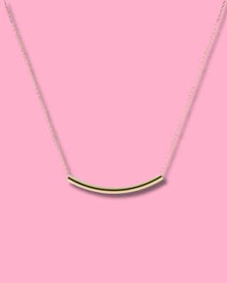 Necklace with a green bar pendant on a pink background