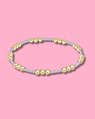 Two-toned beaded bracelet on a pink background