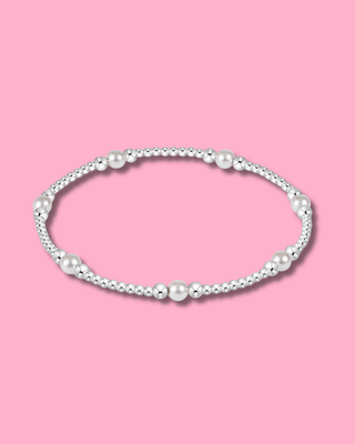 Pearl necklace on a pink background