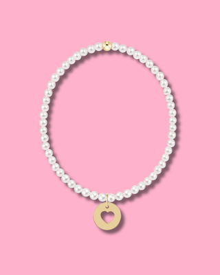 Pearl necklace with a gold heart pendant on a pink background