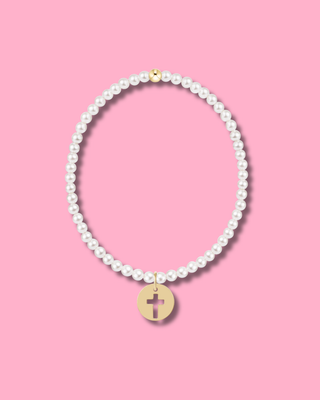 Pearl necklace with a gold cross pendant on a pink background