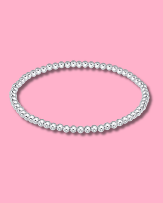 Pearl bracelet on a pink background
