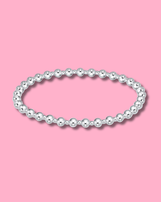 Pearl bracelet on a pink background