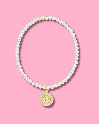 Pearl necklace with a gold pendant on a pink background
