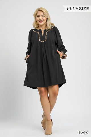 Woman wearing a black dress with decorative elements on a white background