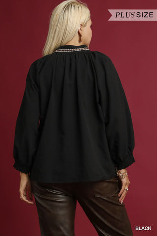 Person wearing a black blouse with a red background