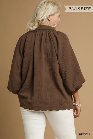 Woman wearing a brown plus-size jacket on a beige background