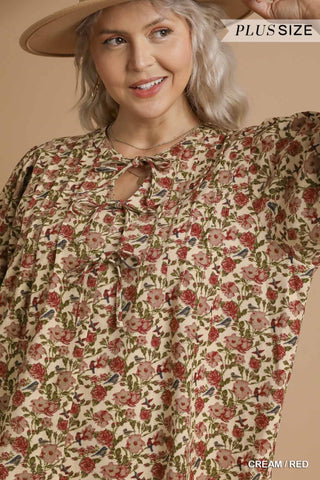 Woman wearing a floral blouse with a beige hat on a beige background
