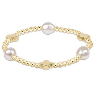 Gold bracelet with pearls on a white background