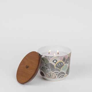 Candle with wooden lid on a white background