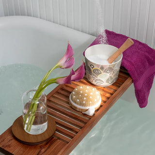 Bath tray with a bowl, towel, and other items in a bathtub setting