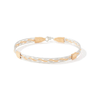 Two-toned silver and gold bracelet on a white background