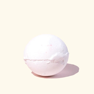 White bath bomb on a light beige background