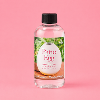 Bottle of Patio Egg mosquito deterrent refill oil on a pink background
