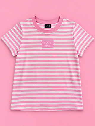A pink and white striped short-sleeve t-shirt with a pink chest patch reading 'LOLU MAC' in white text, displayed flat against a solid pink background.