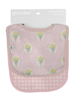 Pink bib with floral pattern and checkered bottom, packaging visible