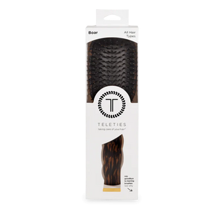Hairbrush packaging with brand logo on a white background