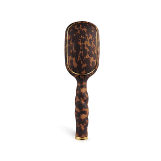Tortoiseshell paddle brush on a white background