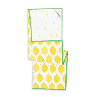 Two patterned towels with lemon and polka dot designs on a white background