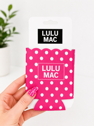Pink polka dot can cooler with 'LULU MAC' branding held by a hand.