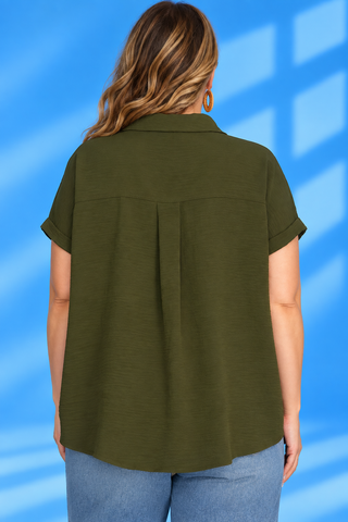 A woman viewed from the back wearing an olive green short-sleeve collared blouse with a pleated back detail, paired with light blue jean