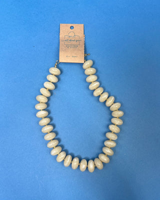 Chunky marbled resin bead statement necklace with oversized cream beads, gold-tone spacer accents, adjustable clasp closure