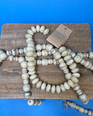 Chunky marbled resin bead statement necklace with oversized cream beads, gold-tone spacer accents, adjustable clasp closure