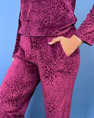 Burgundy velvet animal print lounge set with a V-neck long sleeve top and matching relaxed-fit pants.