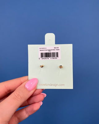 eNewton Small Gold Cross Stud Earrings in classic gold featuring petite gold cross studs with polished gold ball accents and secure post backs displayed on an eNewton jewelry card.