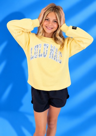 Butter Yellow & White Camo Patch Sweatshirt with cozy fleece lining and oversized camo patch lettering.