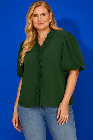 Green blouse with ruffled neckline on a blue background