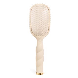 Beige hairbrush with gold accent on a white background