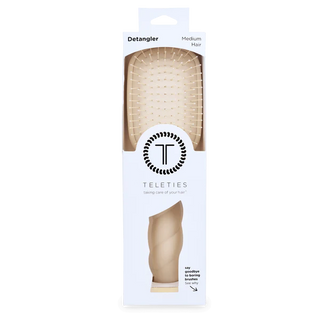 Teleties detangler brush packaging on a white background