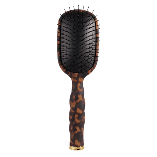 Hairbrush with tortoiseshell handle on a white background