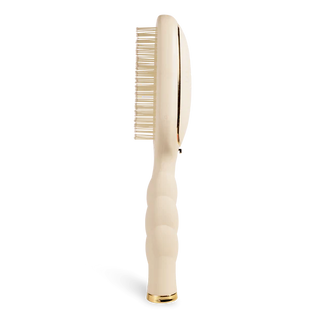 Beige hairbrush on a white background