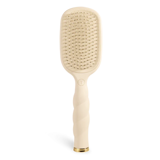 Beige paddle hairbrush on a white background