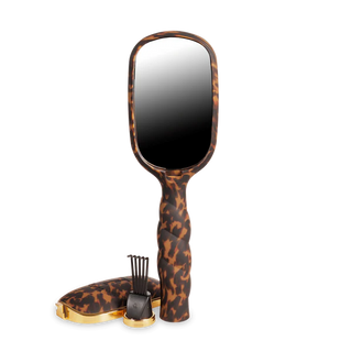 Handheld mirror with leopard print handle on a white background