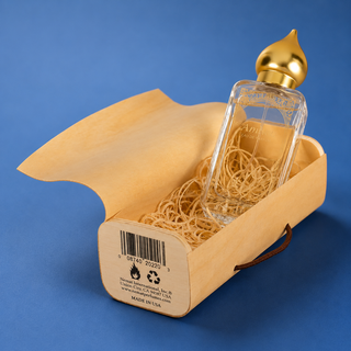Perfume bottle with gold cap in a box on a blue background