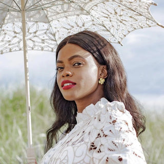 Woman with a white face mask outdoors under an umbrella