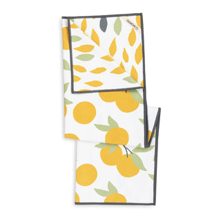 Two kitchen towels with lemon and leaf patterns on a white background