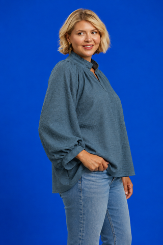 Blue Button Up Tiered Denim Top in soft 100% Tencel with a button front, chest pocket, tiered peplum hem, and relaxed fit.