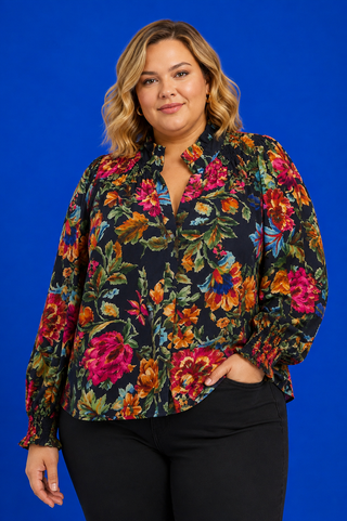 V-Neck Navy Top featuring a watercolor floral print, smocked neckline, long sleeves, and a relaxed plus-size fit.