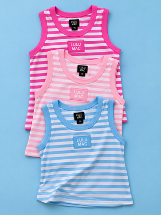 Three sleeveless striped tank tops from Lulu Mac are stacked diagonally on a light blue background. The top tank is pink and white striped with bright pink trim.