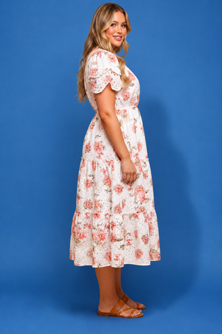 Woman wearing a floral dress against a blue background