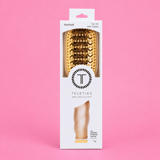 Hairbrush packaging with 'Teleties' branding on a pink background