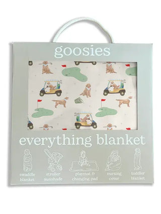 Goosies everything blanket packaging with a pattern of dogs and golf carts on a white background.