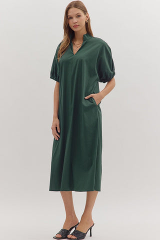 Woman wearing a green dress on a white background