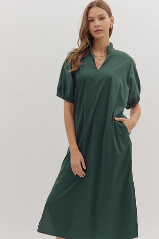 Woman wearing a green dress against a white background